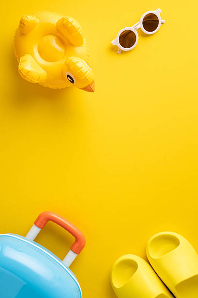 istock Bright vertical image featuring travel and summer items, including float, sunglasses, and suitcase, evoking holiday vibes 2216334974