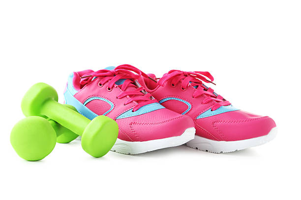 istock Sport shoes with dumbbells isolated on a white background 2216336509