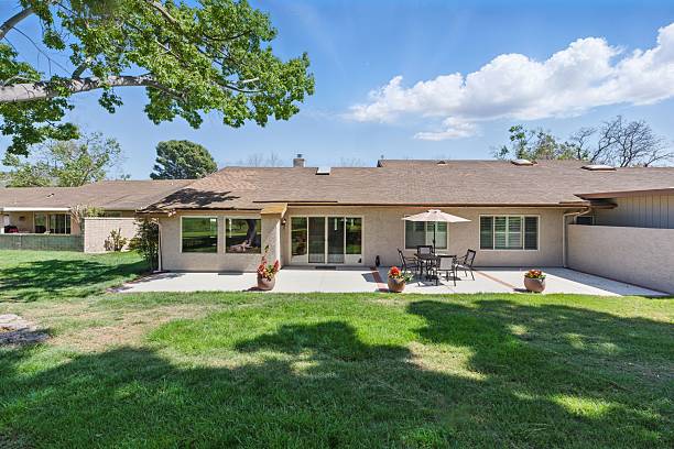 istock Suburban backyard with patio and lawn. 2216337531