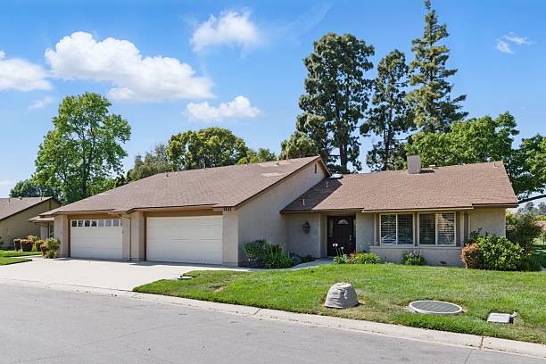 istock Suburban house with driveway and lawn. 2216337538