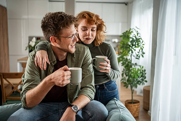 Young couple enjoying coffee in cozy home setting