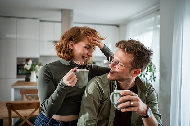 istock Young adults enjoying coffee and laughter at home 2216339824