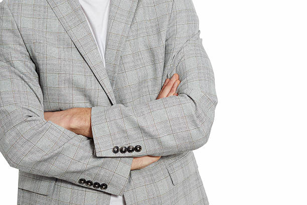 istock Stylish businessman in a gray suit posing on a plain white background. Ideal image for corporate, fashion, or recruitment-related themes. 2216341344