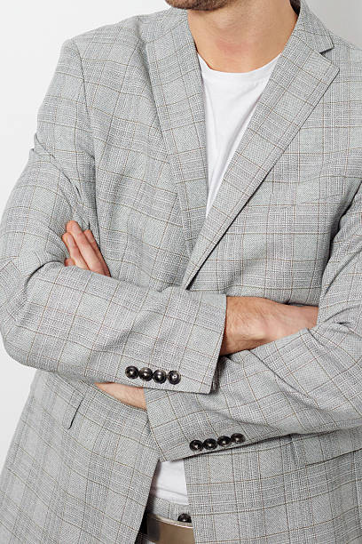 istock Stylish businessman in a gray suit posing on a plain white background. Ideal image for corporate, fashion, or recruitment-related themes. 2216341345