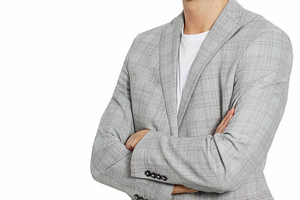 istock Stylish businessman in a gray suit posing on a plain white background. Ideal image for corporate, fashion, or recruitment-related themes. 2216341351