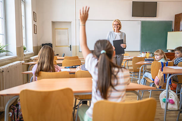 istock school kid raise hand to answer a question during a lesson 2216341481