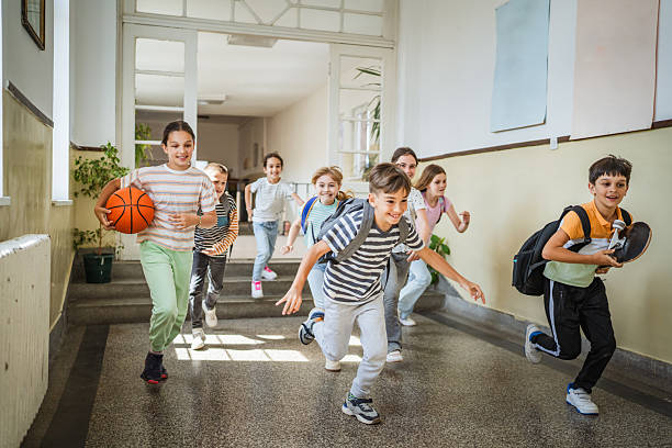 istock boys and girls classmates run through the school hallway 2216341861