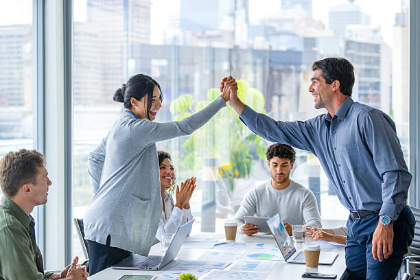 istock Business team members giving each other a high five celebration 2216347680