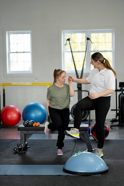 istock Inclusive Fitness Training Session Between Instructor and Individual at Gym 2216352347