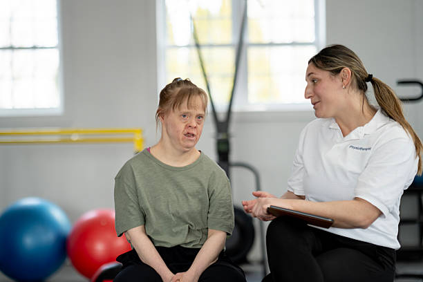 istock Personal Trainer Assisting a Client with Exercises in a Gym Setting 2216352405