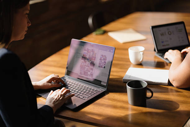 istock Two businesswomen working on laptops in a modern office 2216352514