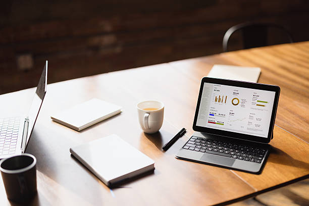 istock Business person analyzing financial charts and graphs on a tablet computer 2216352530