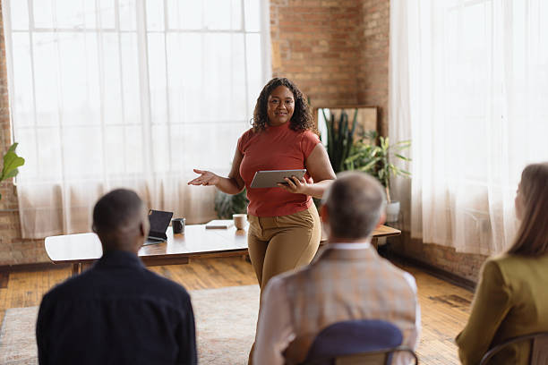 istock Confident young woman leads a business meeting using a digital tablet 2216352572