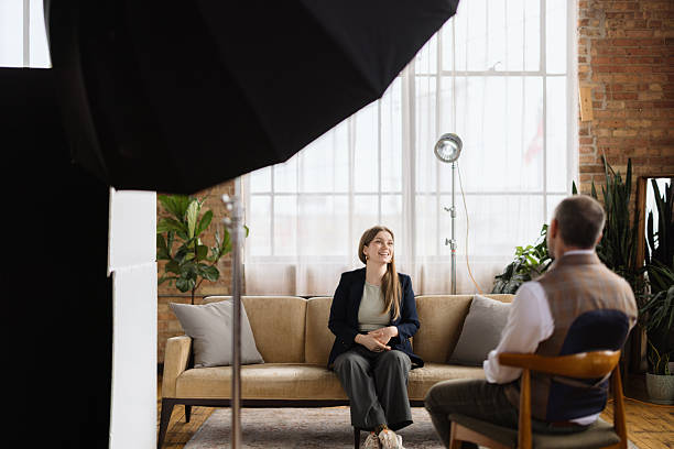 istock Young woman being interviewed by journalist in modern studio 2216352679