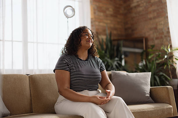 istock Young woman relaxing on sofa looking up at home 2216352687