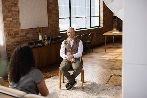 istock Mature man sitting and talking to a woman during therapy session 2216352689