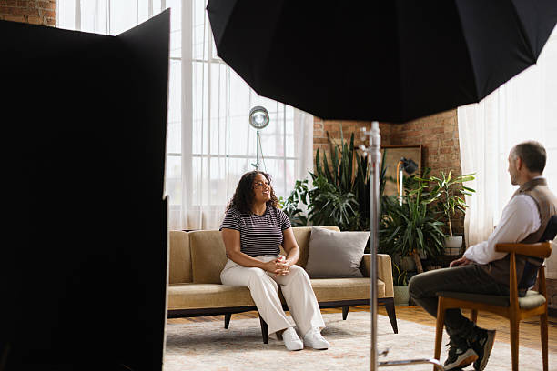 istock Young woman being interviewed by a journalist in a photo studio 2216352693