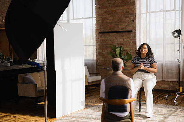 istock Young woman being interviewed by journalist in modern loft studio 2216352734