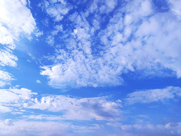 Serene blue sky filled with soft, white clouds. Represents hope, freedom, and inspiration. Ideal for backgrounds, travel themes, or conveying optimism.