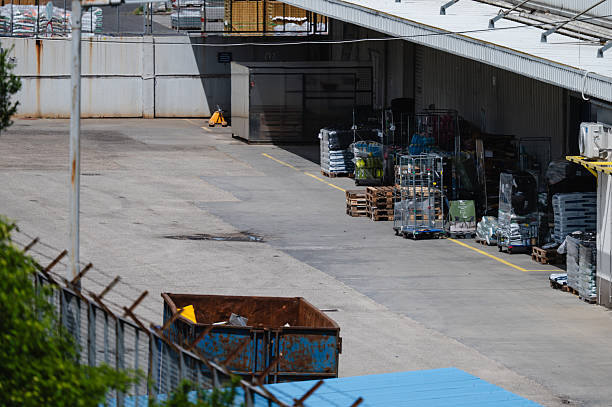 istock Backyard of industrial warehouse with pallets and containers 2216353547