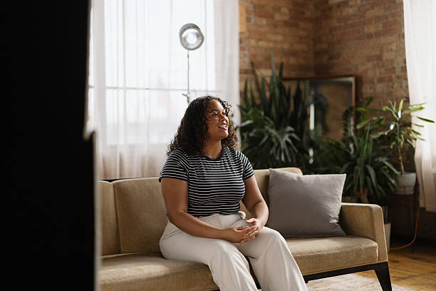 istock Young woman sitting on a sofa during a video interview 2216360827