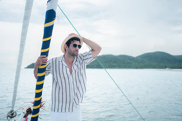 A young man is enjoying his seaside adventure aboard a yacht