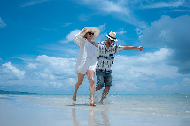 istock Young couple on vacation on a white sandy beach, clear sky and sea 2216368225