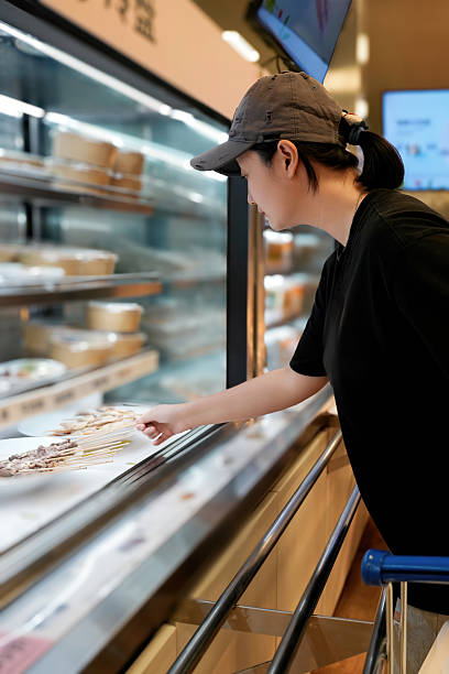 Woman Choosing Food in Refrigerated Display Case
