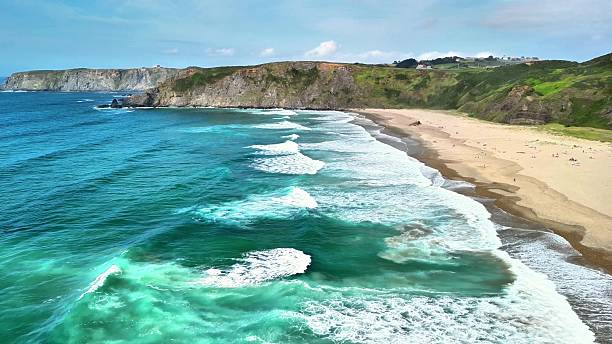 istock Stunning Coastal View Featuring Waves Gently Crashing Against the Sandy Beach Shoreline 2216370098