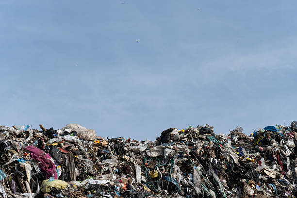 istock Large Mountain of Discarded Waste Materials at Landfill Under Open Blue Sky 2216370850