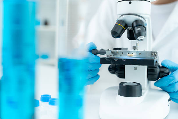 istock Scientist analyze biochemical samples in advanced scientific laboratory. Medical professional use microscope look microbiological developmental of viral. Biotechnology research in science lab. 2216371431