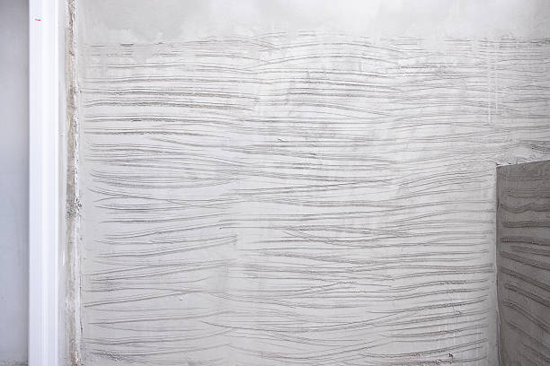 istock Concrete plastering wall and scrate surface to prepare for tile installation. 2216373084