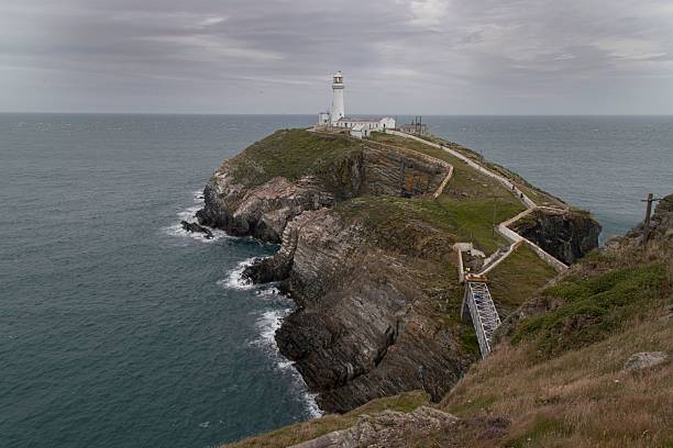 A scenic view of South Stack Lighthouse against the Welsh coastline