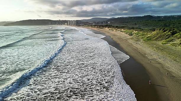 istock Breathtaking Serene Coastal View Featuring Waves Lapping Against a Distant Skyline 2216376610