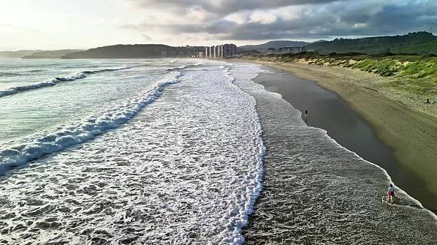 istock A serene beach at sunset has gentle waves lapping at the shore and beautiful coastal views 2216376799