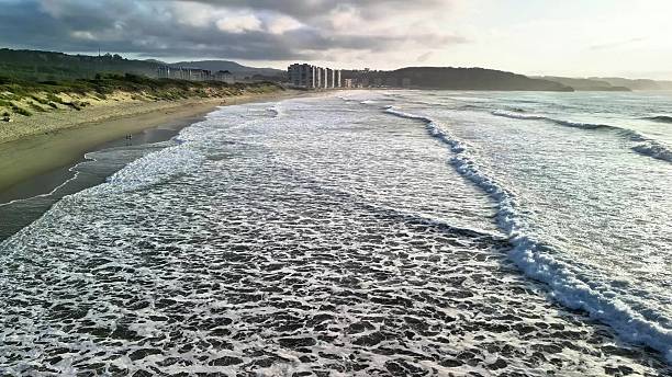 istock Experience the breathtaking coastal view featuring magnificent waves and a stunning sunset 2216377289