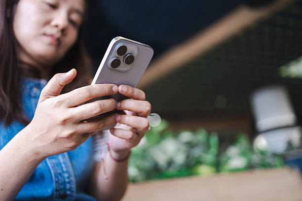 istock Asian woman engaging with ai technology through her smartphone connection in casual setting showing focus and interaction with modern tech devices 2216377453