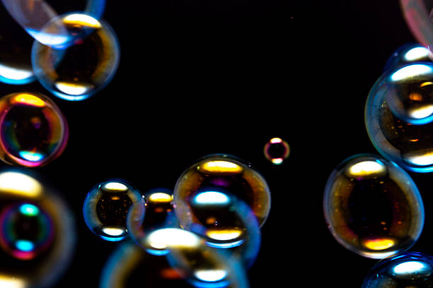 istock Beautiful Colorful Soap Bubbles Floating on Black Background. Clear Bubbles, Freshness Soap Suds Bubbles Water. Celebration Festive Backdrop. Abstract Colorful Blurred Background. 2216377706