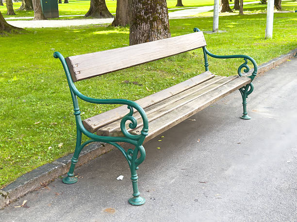 Empty park bench and footpath in the beautiful green city park