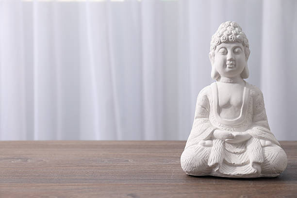 Golden statue of Buddha placed on wooden ornamental chair against lines forming circle. 3d render