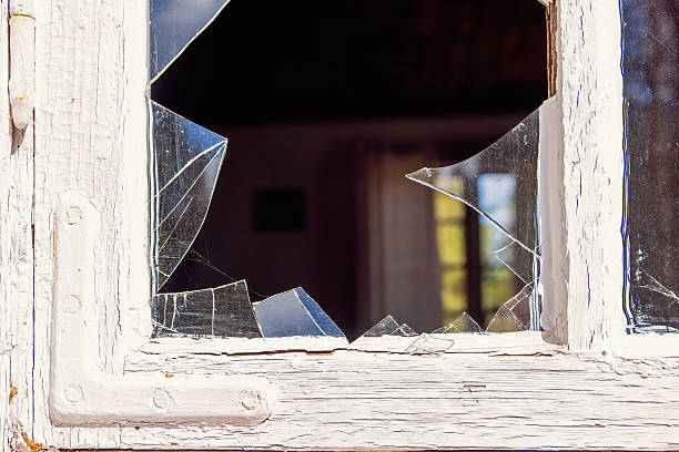 istock Broken glass in a window of an old cottage 2216390021