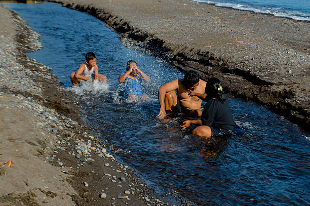 istock Kids splash water playfully while parents soak nearby 2216390672