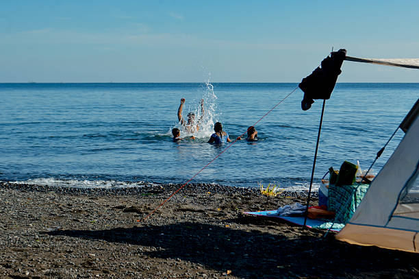 Mature Man on Sea Vacation Having Fun Jumping from the Pier