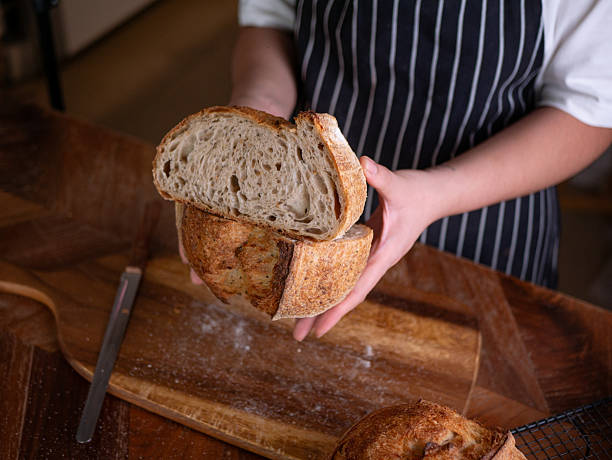 istock Baker's Hand Presenting Homemade Sourdough. 2216391479