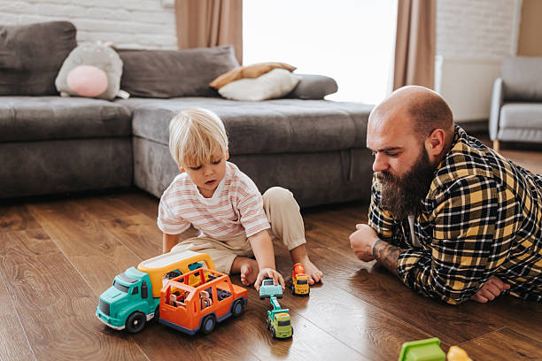 istock Man enjoys playing time with his little son at home 2216391482