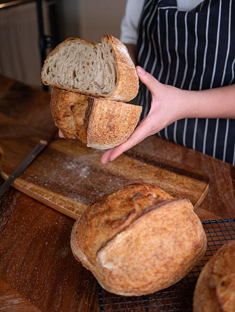 istock Baker's Hand Presenting Homemade Sourdough. 2216391491