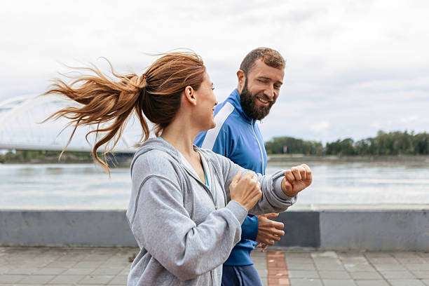 istock Couple Enjoying a Run While Tracking Fitness Goals 2216395453