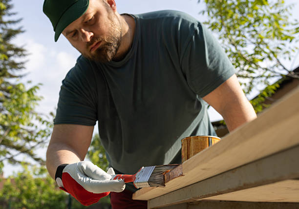 istock Young man painting an old wooden table. 2216398411