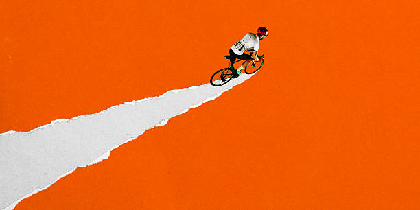 istock Male cyclist speeds forward on torn white road across vibrant orange background. Dynamic graphic design. Concept of sport, game, competition, endurance, road cycling 2216398533