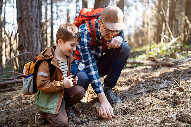 istock A father and son are exploring the forest and learning about nature together 2216398615